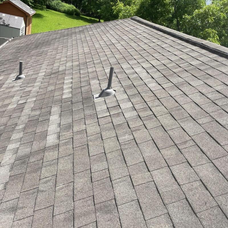 Plumbing vent pipe boot flashing and roof shingles