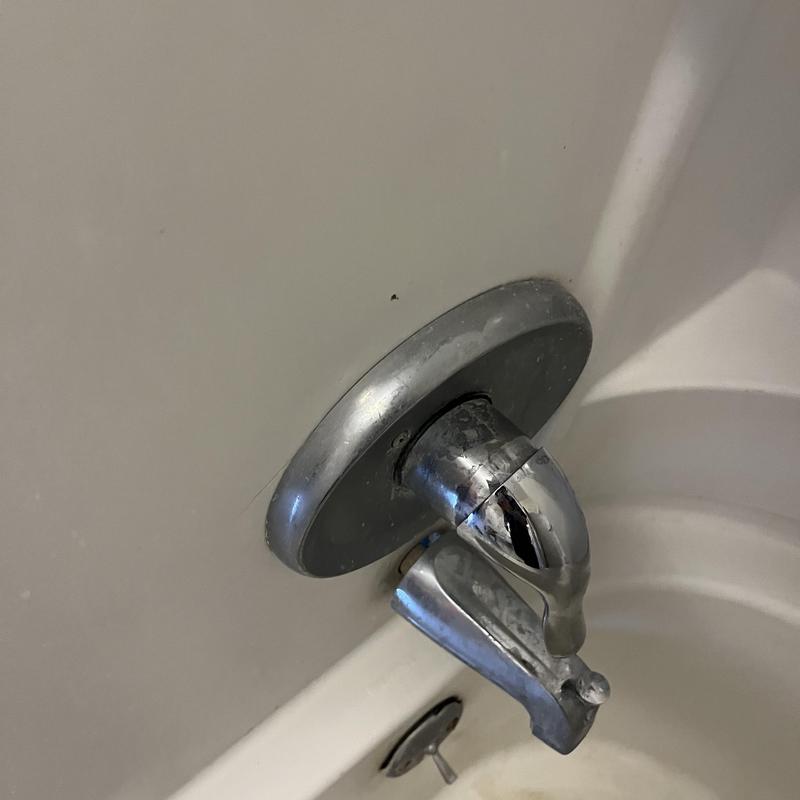 Bathtub faucet with visible crack and corrosion Bathtub faucet with visible crack and corrosion