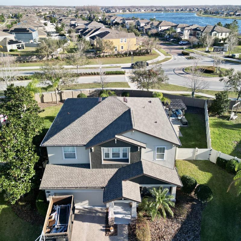 Architectural shingle roof on two-story home in Florida Architectural shingle roof on two-story home in Florida