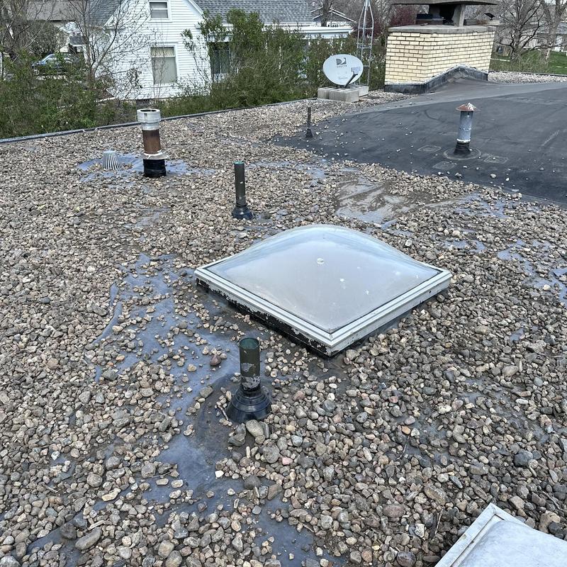 Skylight and gravel-covered flat roof vent pipes Skylight and gravel-covered flat roof vent pipes