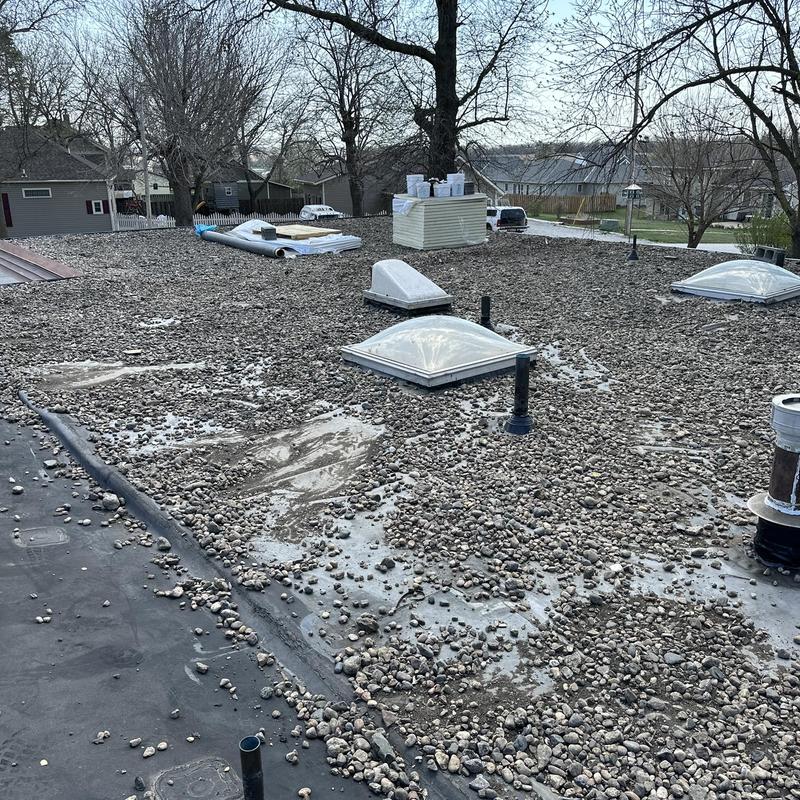 Gravel-covered flat roof with skylights and vents Gravel-covered flat roof with skylights and vents