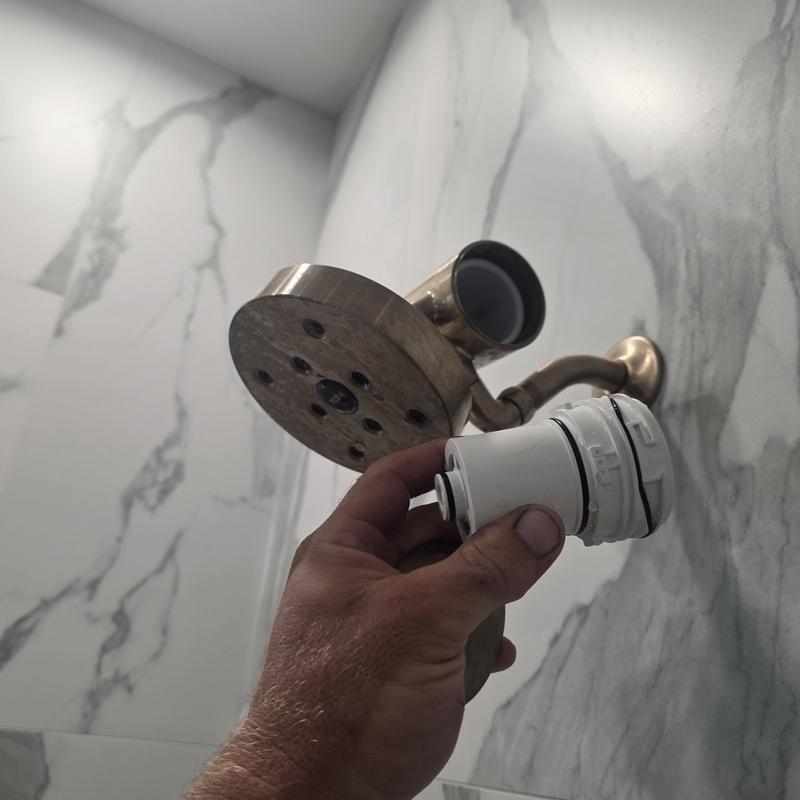 Shower head filter being cleaned for pressure restoration Shower head filter being cleaned for pressure restoration