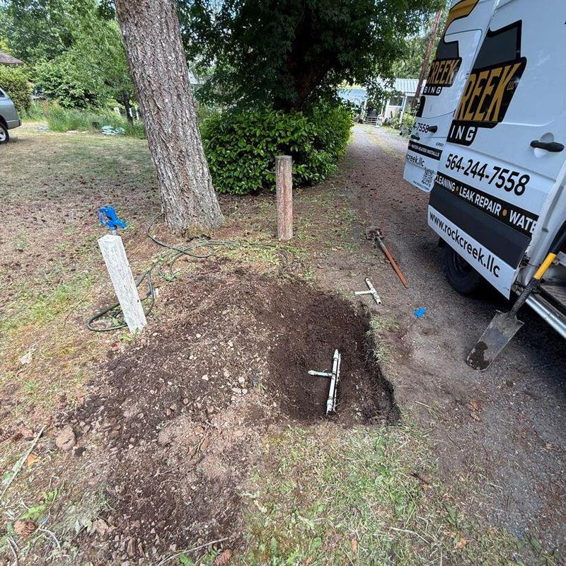 Main water line excavation with leak repair outdoors