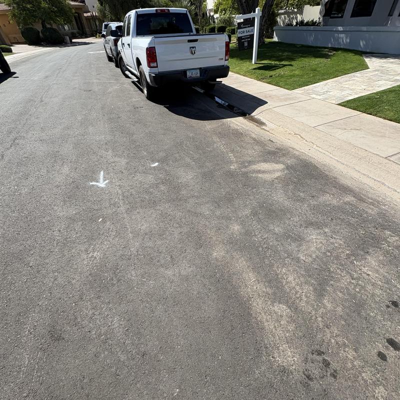 Storm drain with parked trucks and street markings