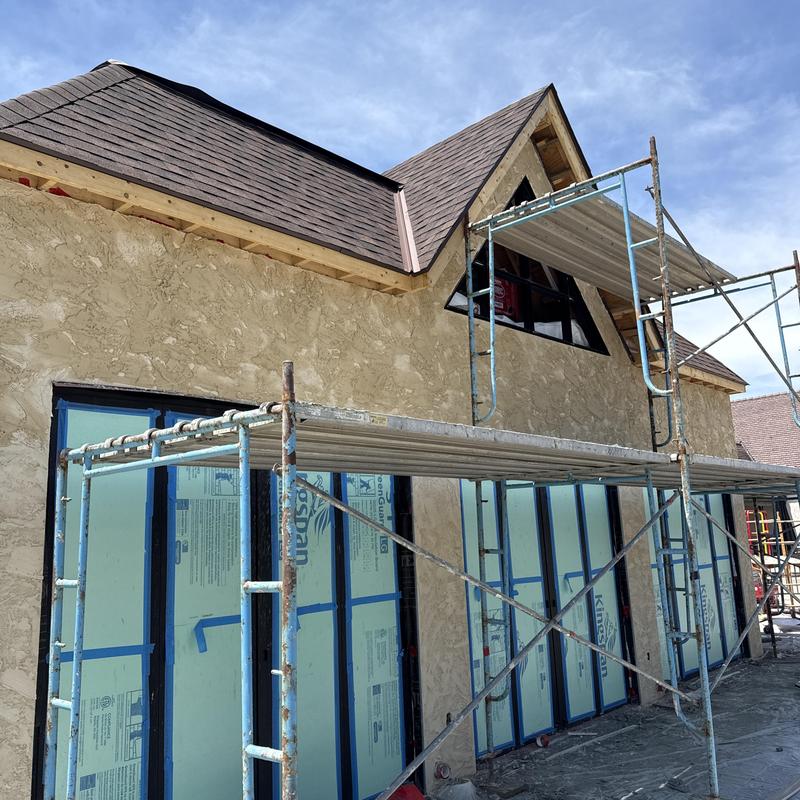 Roof shingles and scaffolding on building addition