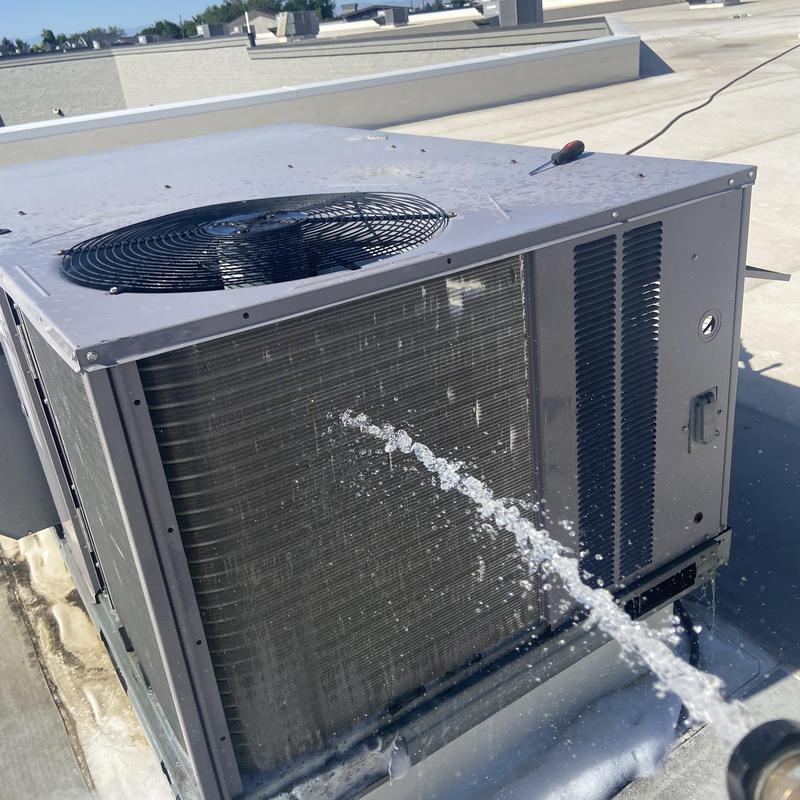 Rooftop HVAC unit with refrigerant leak spraying fluid Rooftop HVAC unit with refrigerant leak spraying fluid