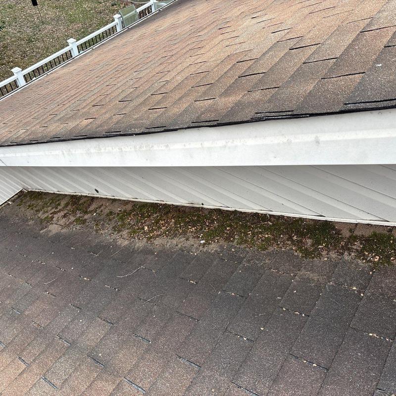 Asphalt shingles with hail damage near ridge vents