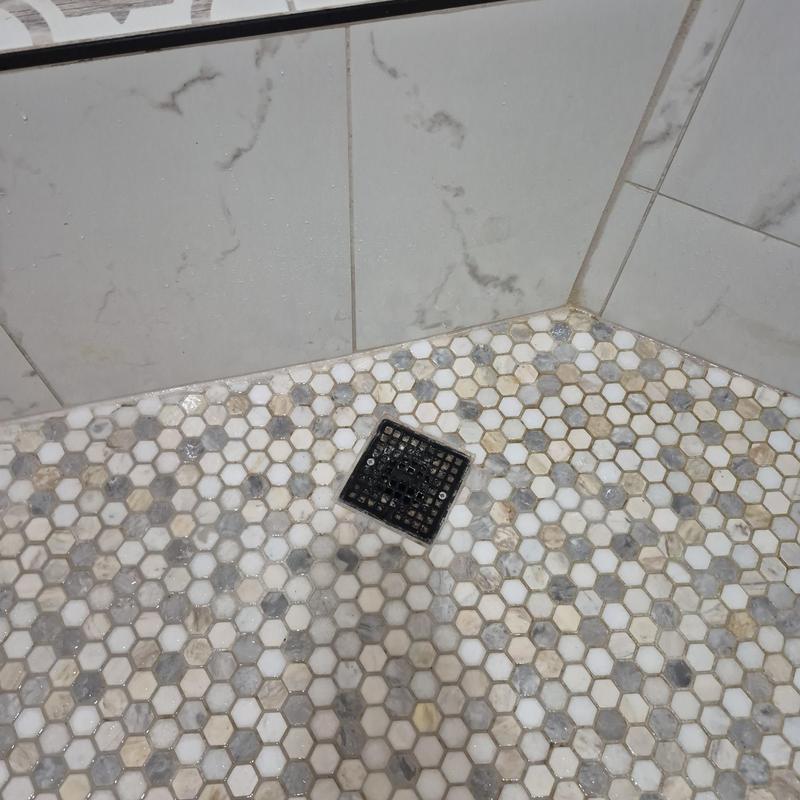 Tub shower drain with hex tile floor and wall tiles