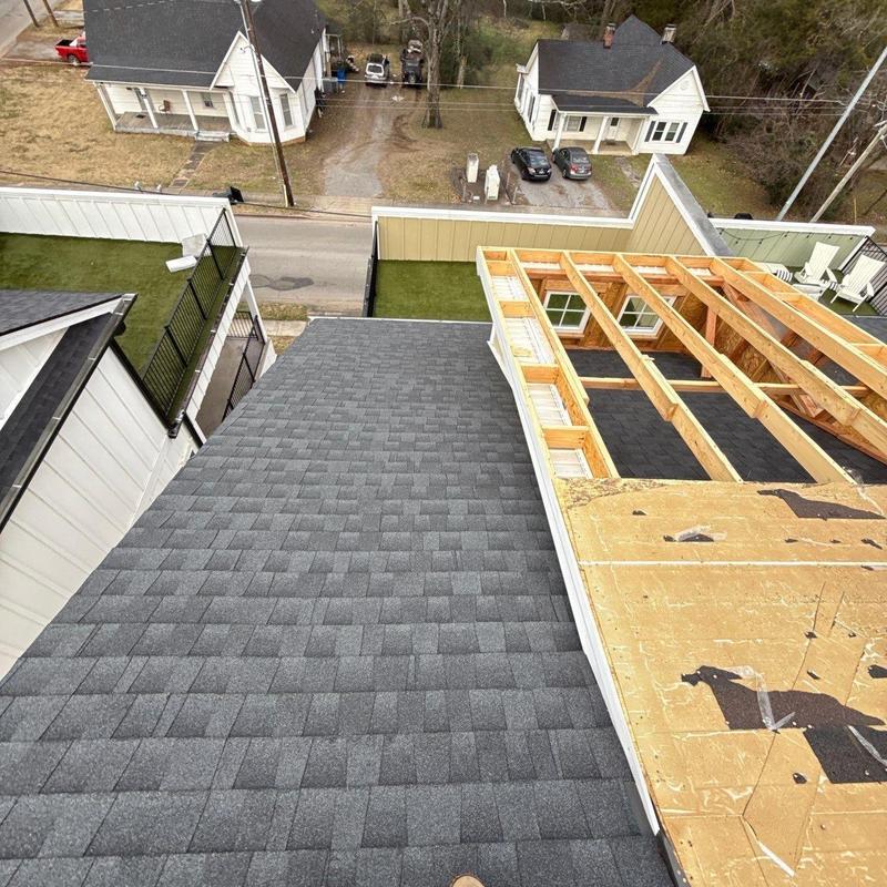 Asphalt shingle roof with framing exposed for repair