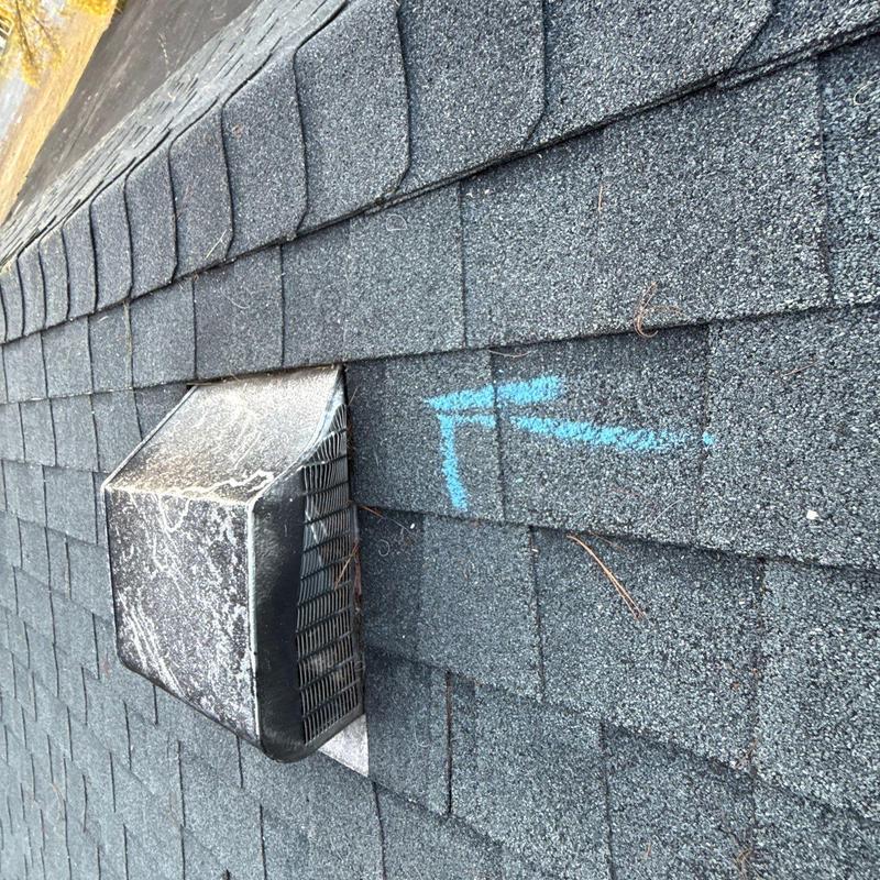 Asphalt shingle roof with vent and hail damage marks