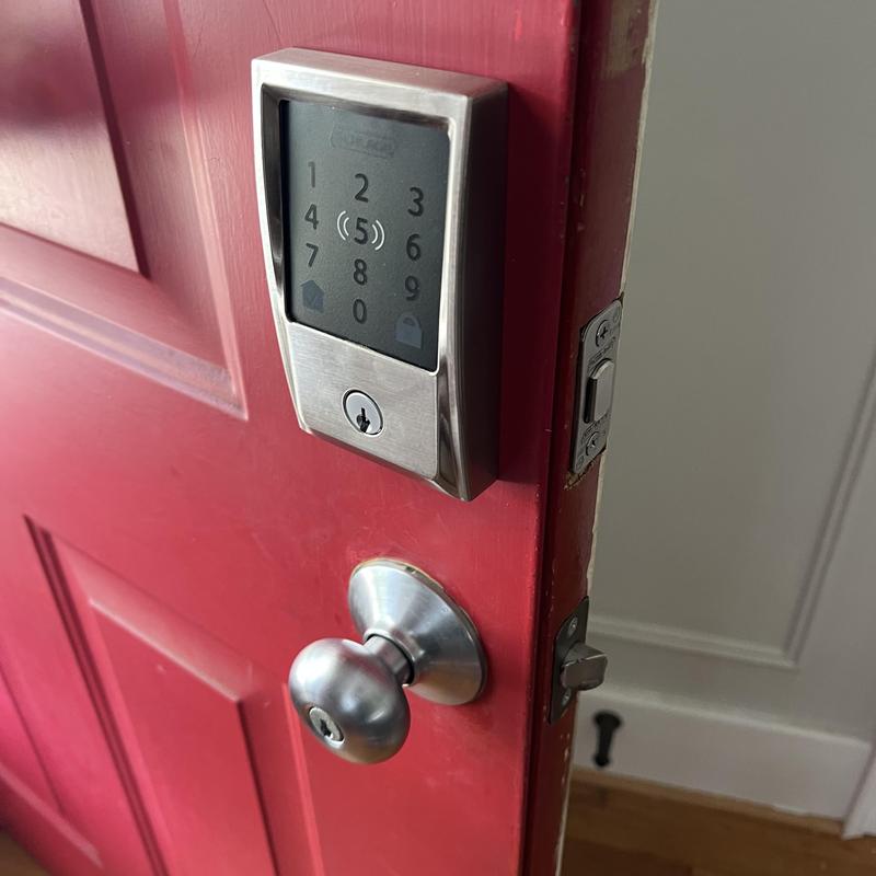 Electronic Schlage deadbolt installed on red door