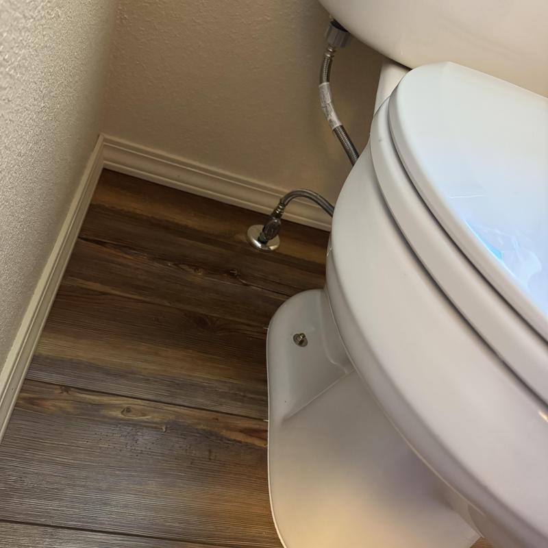 Toilet installation with supply line on wood floor Toilet installation with supply line on wood floor