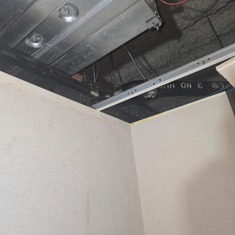 Cast iron plumbing overhead tied into main stack in ceiling