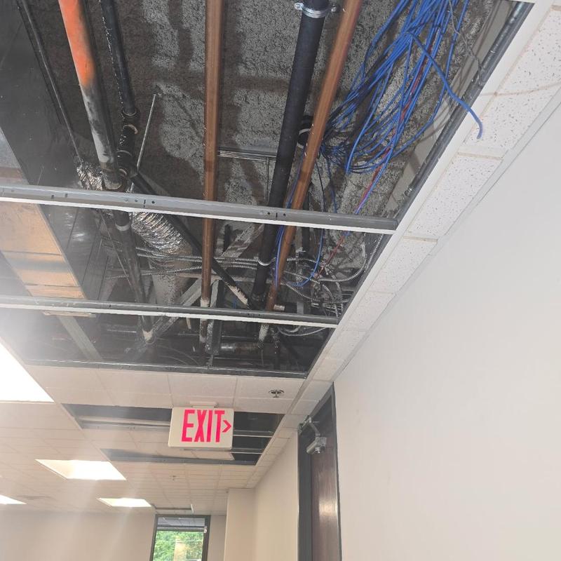Cast iron pipe overhead tied into main stack ceiling