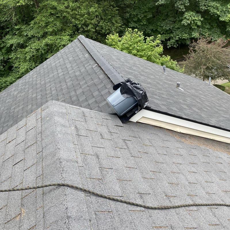 Roof shingles and gutter with cleaning debris on roof