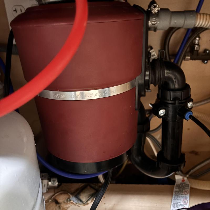 Garbage disposal unit and plumbing connections under sink