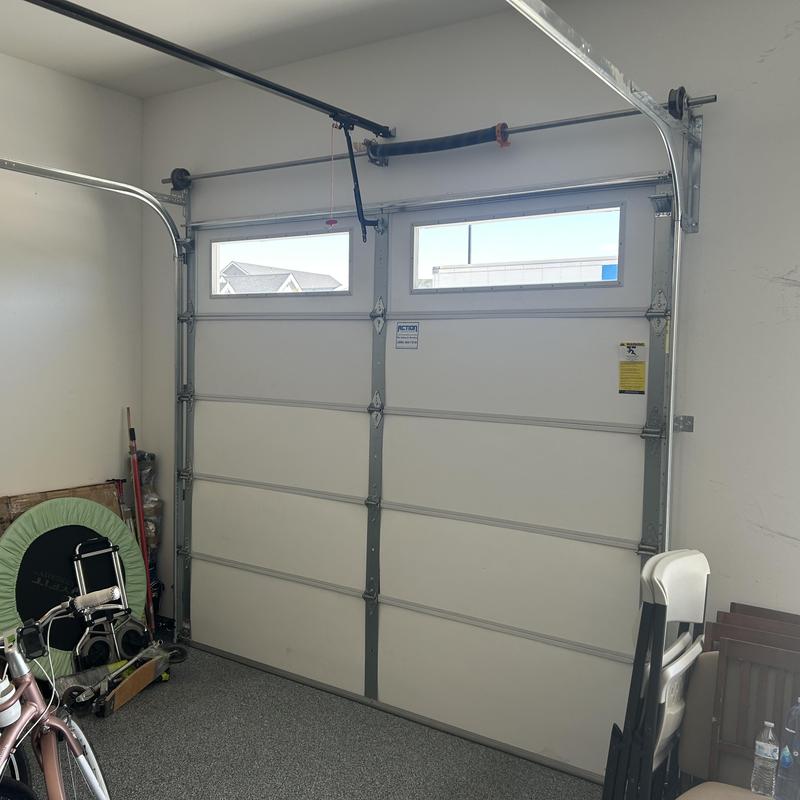 Garage door with window panels and metal frame
