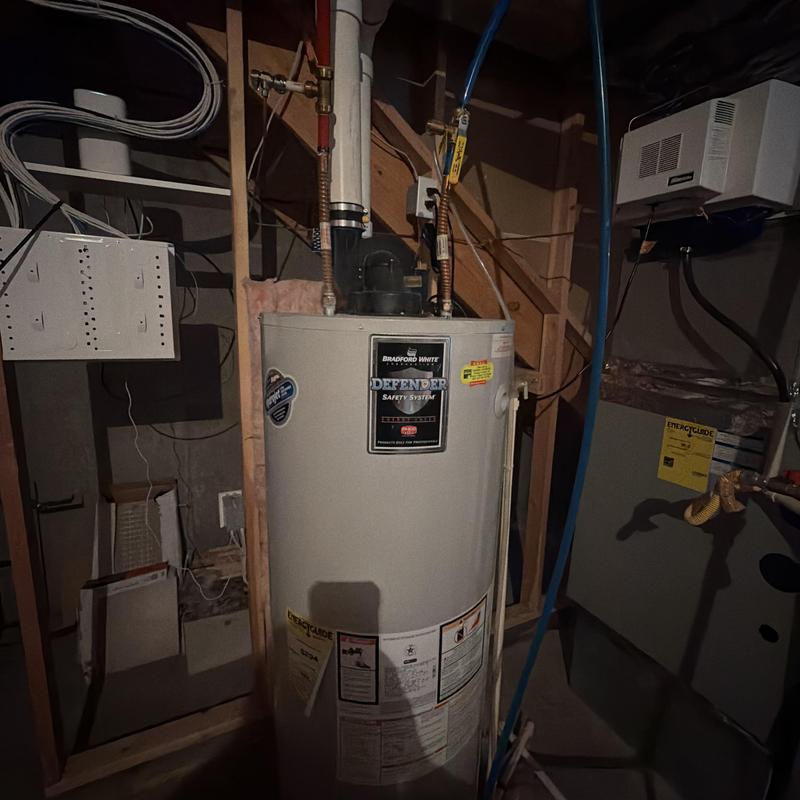 Power vent water heater with vent piping in basement Power vent water heater with vent piping in basement