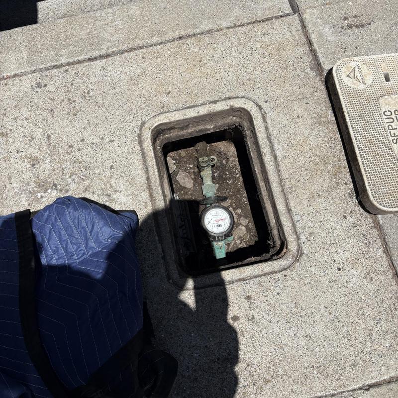 Water meter box relocation on concrete sidewalk