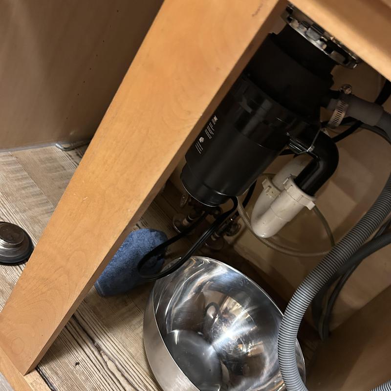 Garbage disposal and sink drain under kitchen cabinet Garbage disposal and sink drain under kitchen cabinet
