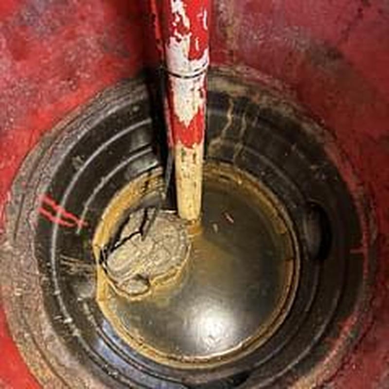 Sump pump pit with repaired leaking pipe Sump pump pit with repaired leaking pipe