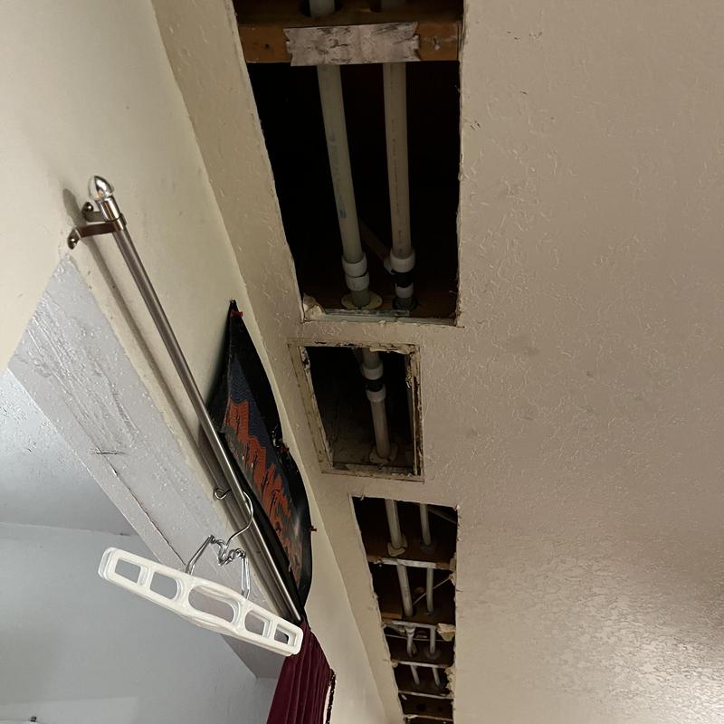PVC water supply pipes inside ceiling with drywall cutouts PVC water supply pipes inside ceiling with drywall cutouts