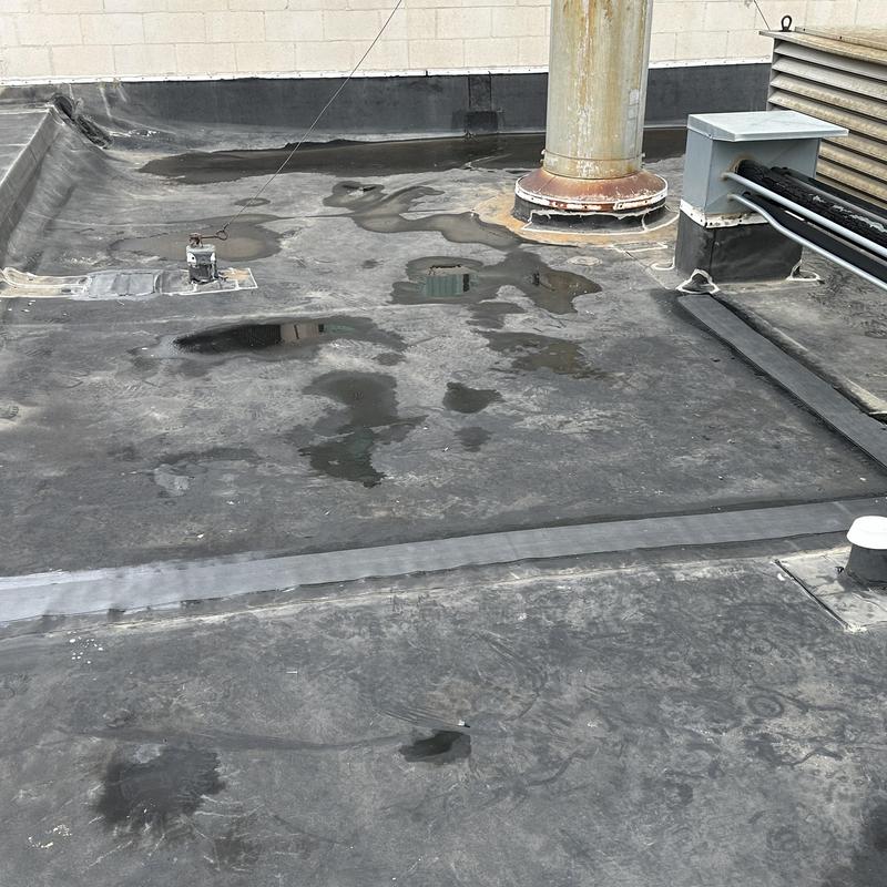 EPDM roof with patched seams and vent pipe base