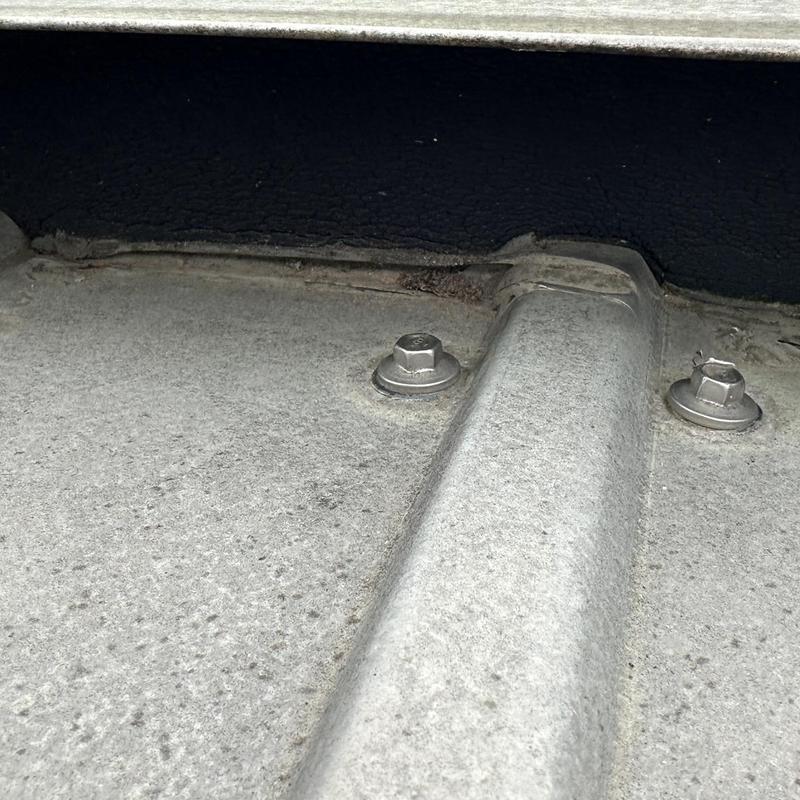 Custom bent ridge cap installation on metal roof