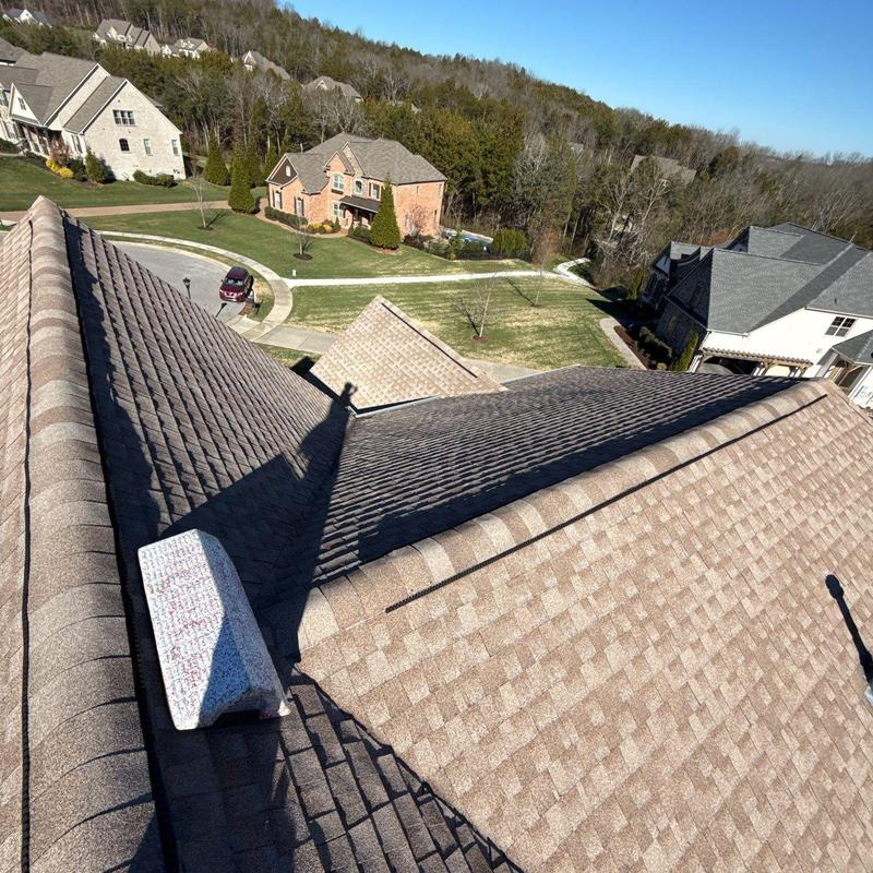 Asphalt shingle roof with ridge cap and valley system