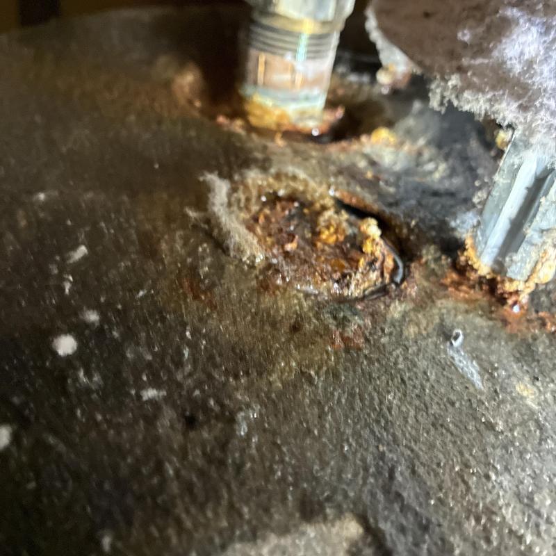 Natural gas water heater rusted leak close-up view