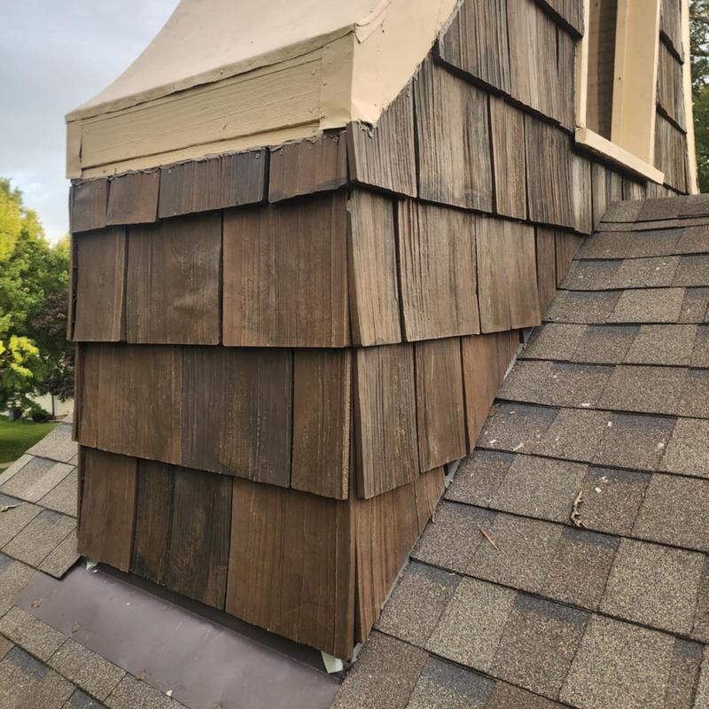Composite cedar shake shingles on roof dormer corner Composite cedar shake shingles on roof dormer corner