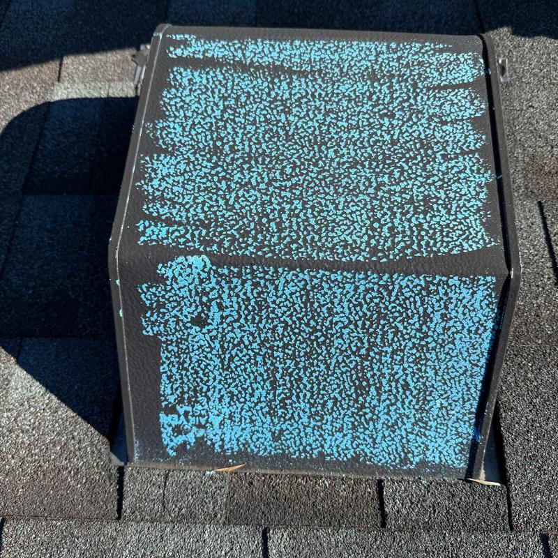 Roof vent with hail damage on shingles and flashing