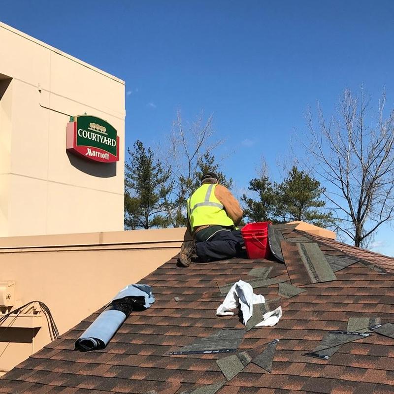 Asphalt shingle roof maintenance on commercial building Asphalt shingle roof maintenance on commercial building