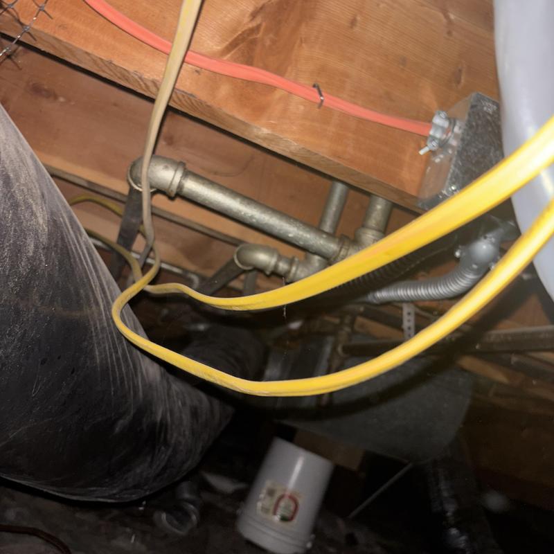 Kitchen sink drain pipes and waterlines under home Kitchen sink drain pipes and waterlines under home