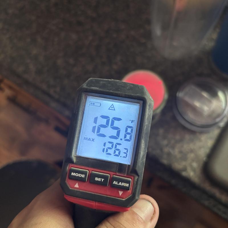 Infrared thermometer showing 125.8°F temperature reading Infrared thermometer showing 125.8°F temperature reading