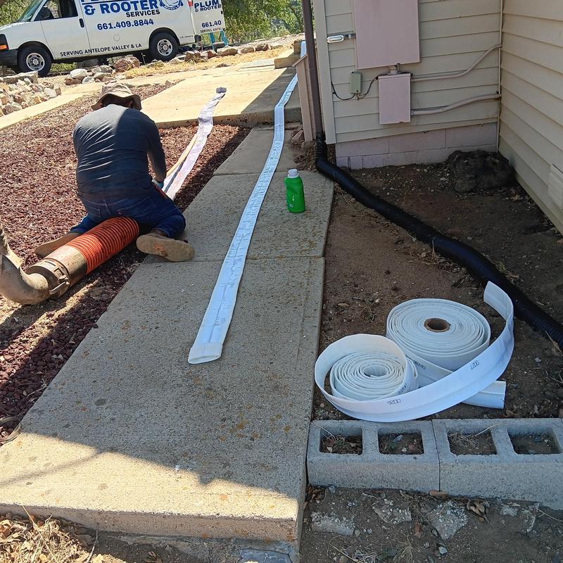 Trenchless sewer line with liner and inspection tape