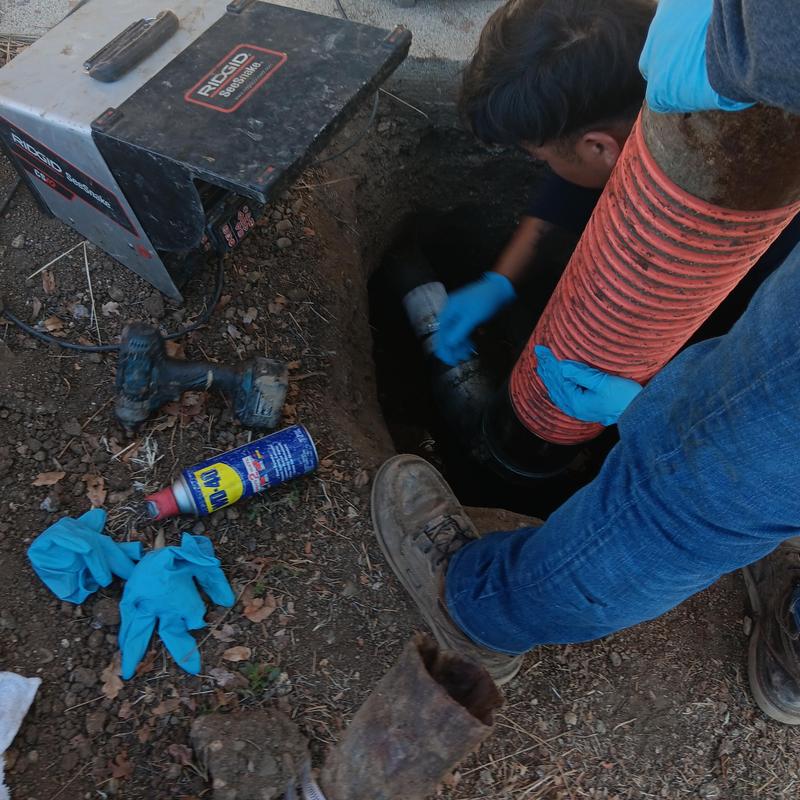 Trenchless sewer line with robotic cutting equipment