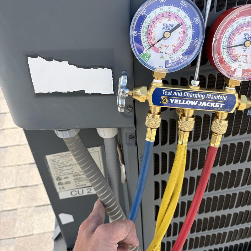 Air conditioner manifold gauges attached for pressure test Air conditioner manifold gauges attached for pressure test