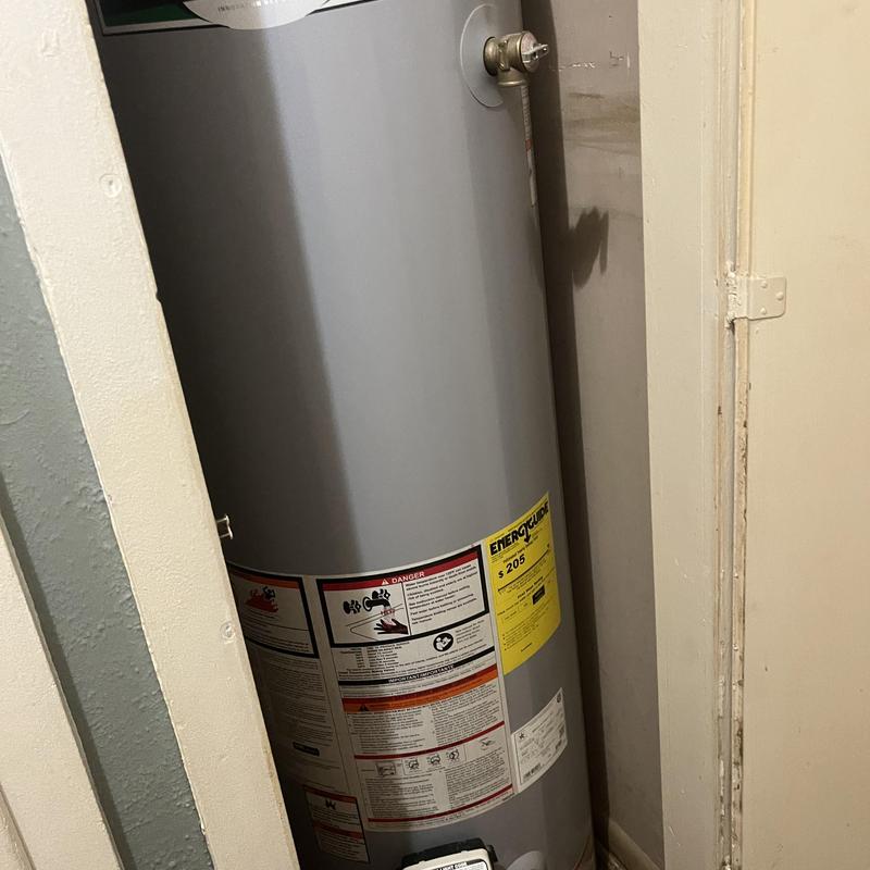 Water heater with warning and energy labels in closet Water heater with warning and energy labels in closet