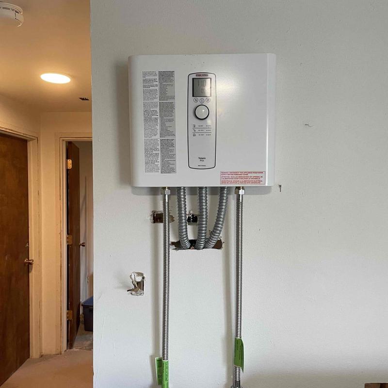Tankless water heater with conduit piping installed Tankless water heater with conduit piping installed
