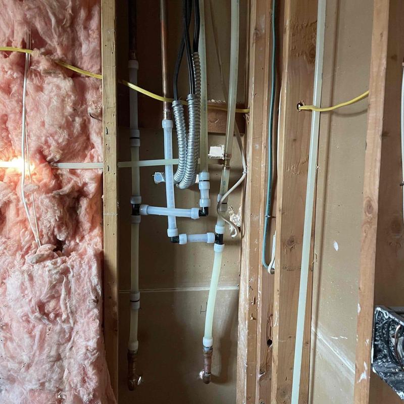 PVC plumbing pipes and flexible conduit in wall cavity PVC plumbing pipes and flexible conduit in wall cavity