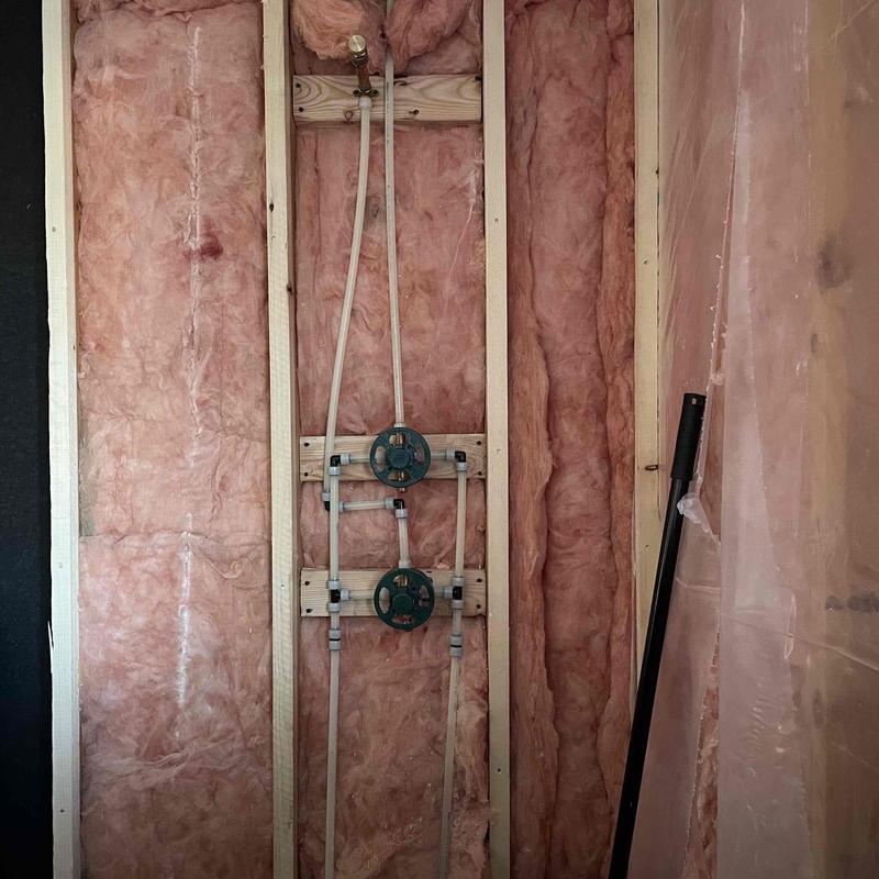 Pex plumbing installation in wall framing with insulation Pex plumbing installation in wall framing with insulation