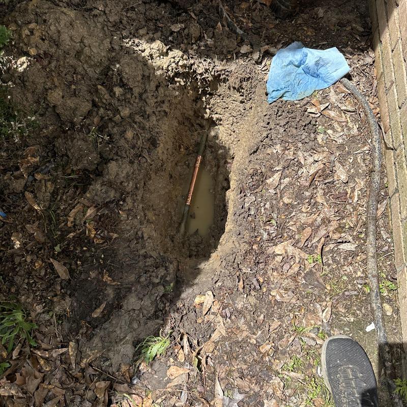 Copper water pipe leak repair in muddy yard trench Copper water pipe leak repair in muddy yard trench