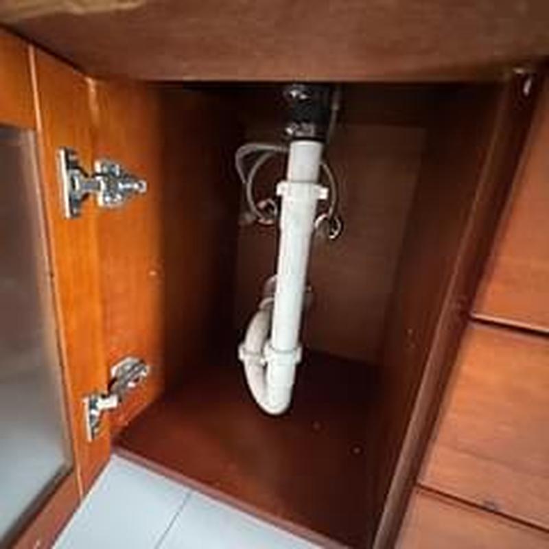 Kitchen sink drain pipe and plumbing under cabinet