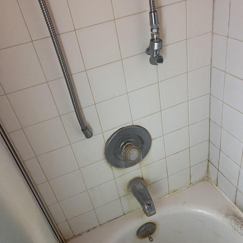 Moen shower valve with corrosion in bathtub wall Moen shower valve with corrosion in bathtub wall