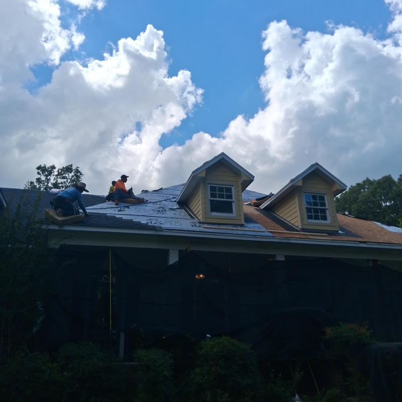 Roof shingles replacement with deck board repair in progress