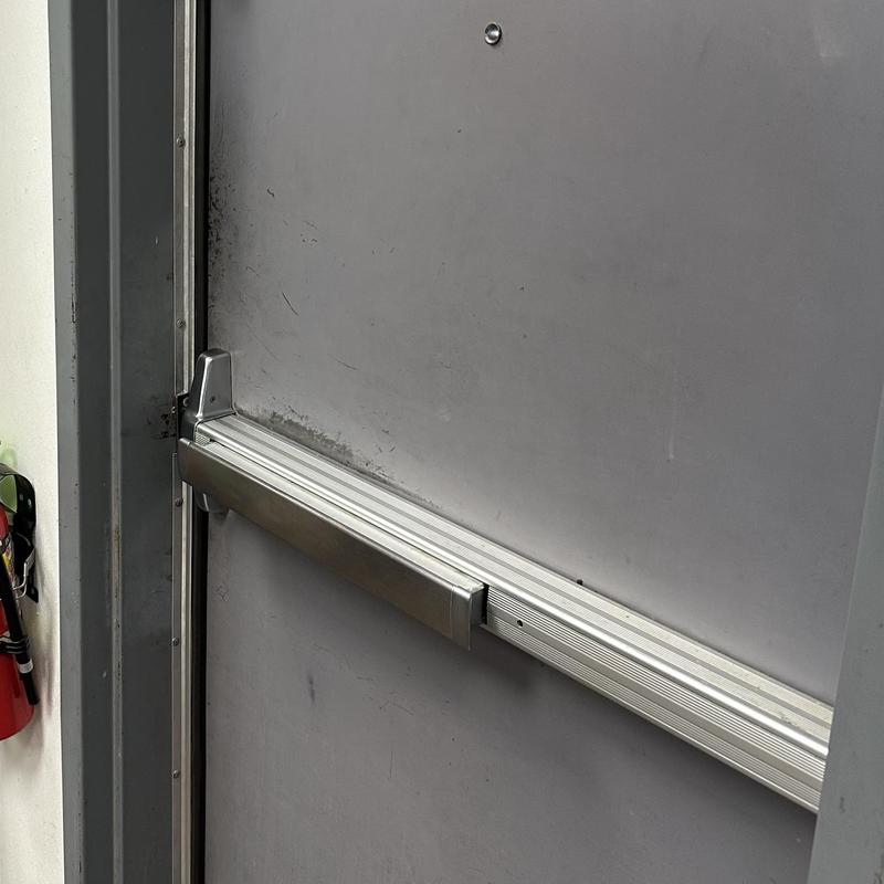 Back door weather stripping installation near panic bar