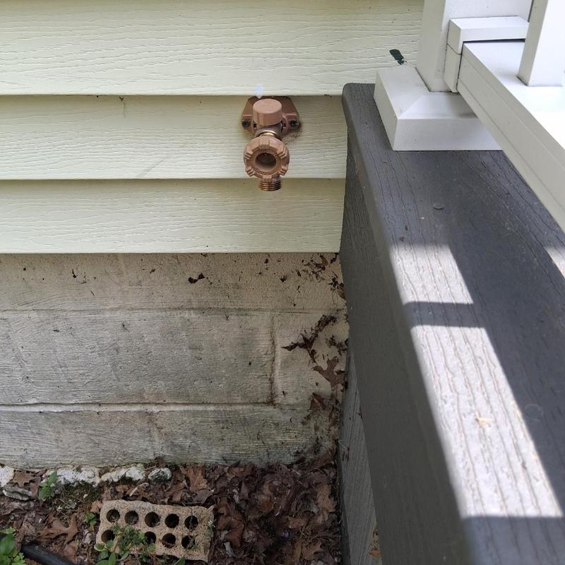 Outdoor water spigot replacement on house exterior wall