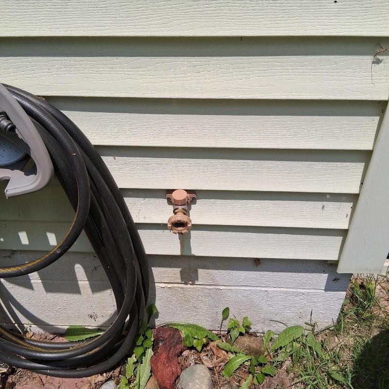 Outdoor water spigot replacement with garden hose nearby