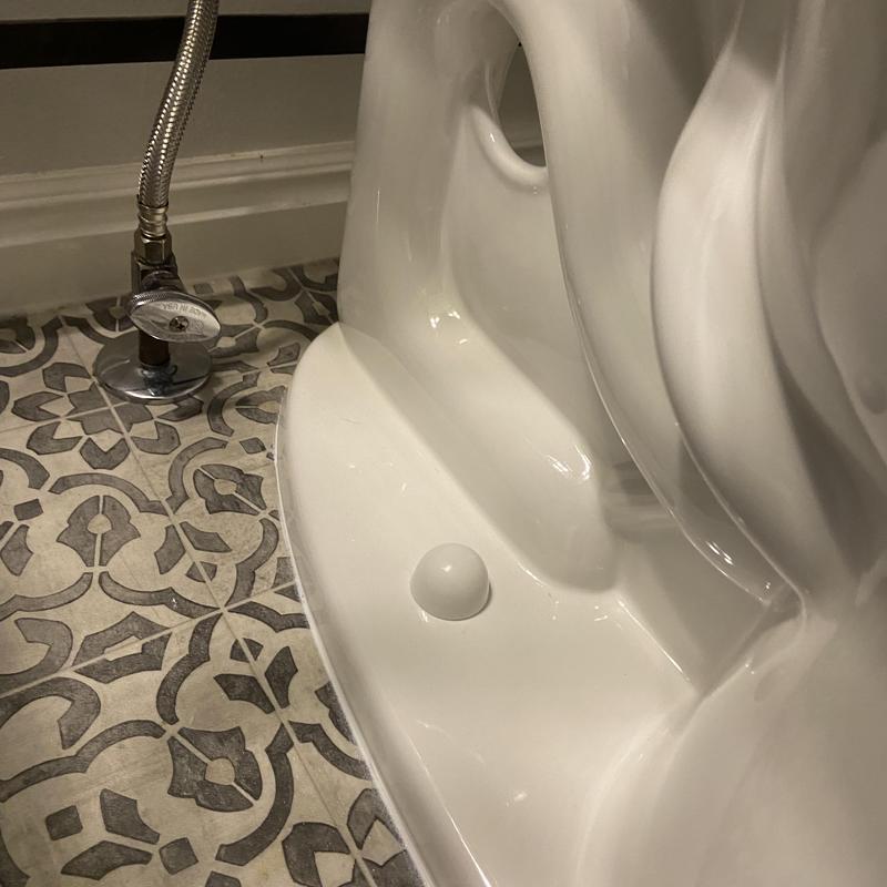 Toilet base with shutoff valve and patterned tile floor